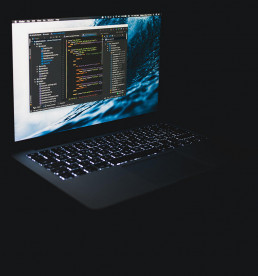 A laptop in the dark with an IDE open